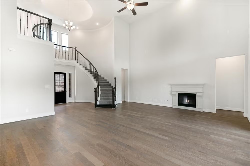 6414 Seville Street Manvel, TX 77578 - Photo 5 of 9 a view of a livingroom with wooden floor staircase and a kitchen space