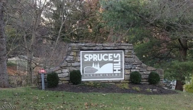 a kitchen with a stove a refrigerator and white cabinets