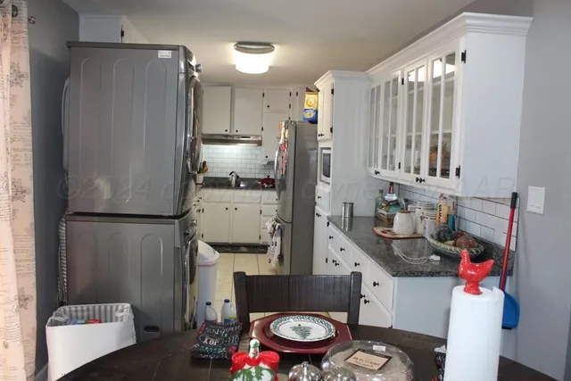 a kitchen with refrigerator and window