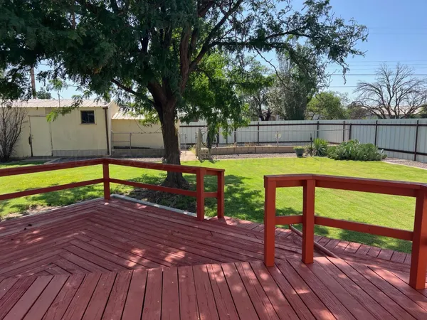 a view of a backyard with sitting area