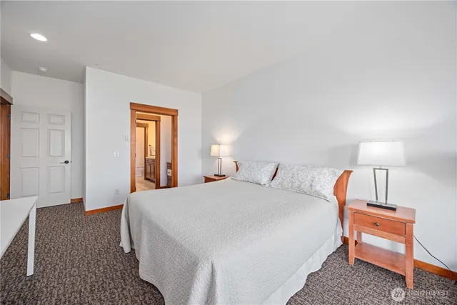 a bedroom with a bed and lamp