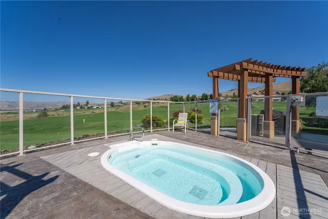 a swimming pool with outdoor seating and yard