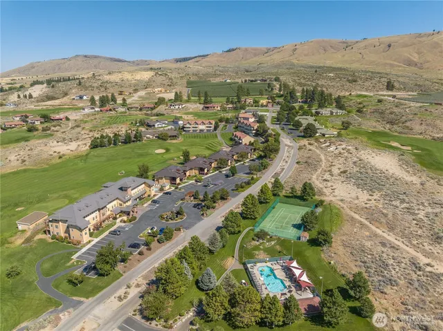 an aerial view of mountains residential house and green space