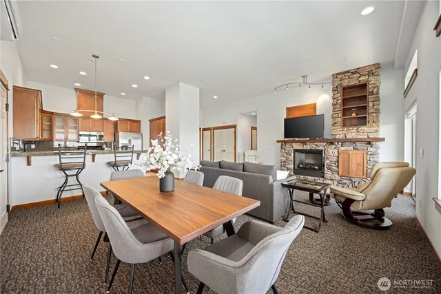 a dining room with a table chairs and a kitchen view