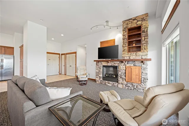 a living room with furniture a fireplace and a flat screen tv