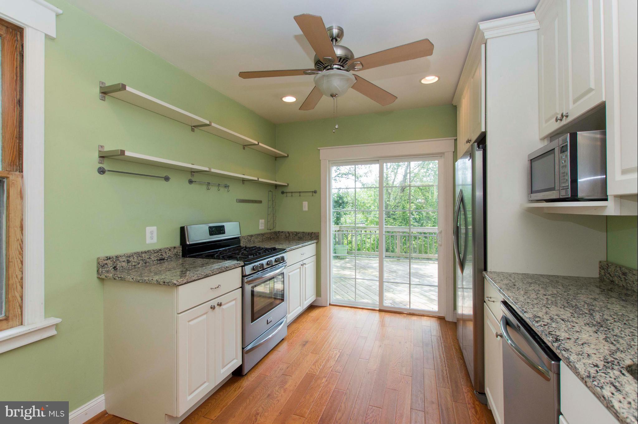 1007 Overbrook Road Baltimore, MD 21239 - Photo 12 of 30 a kitchen with stainless steel appliances granite countertop a stove a sink and a refrigerator