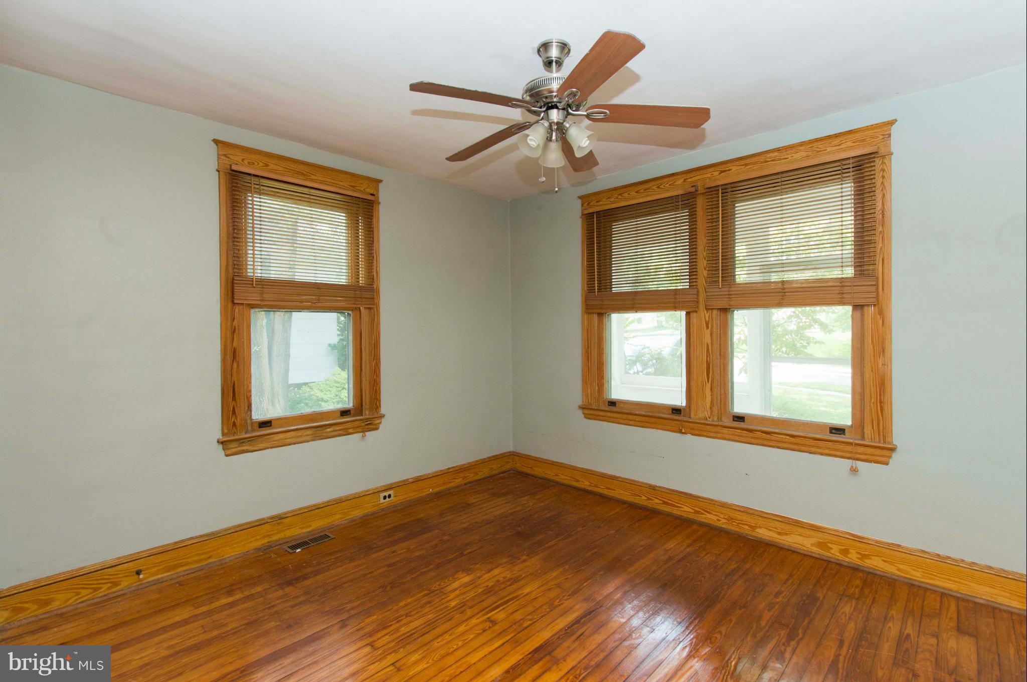 1007 Overbrook Road Baltimore, MD 21239 - Photo 17 of 30 a view of an empty room with wooden floor and a window