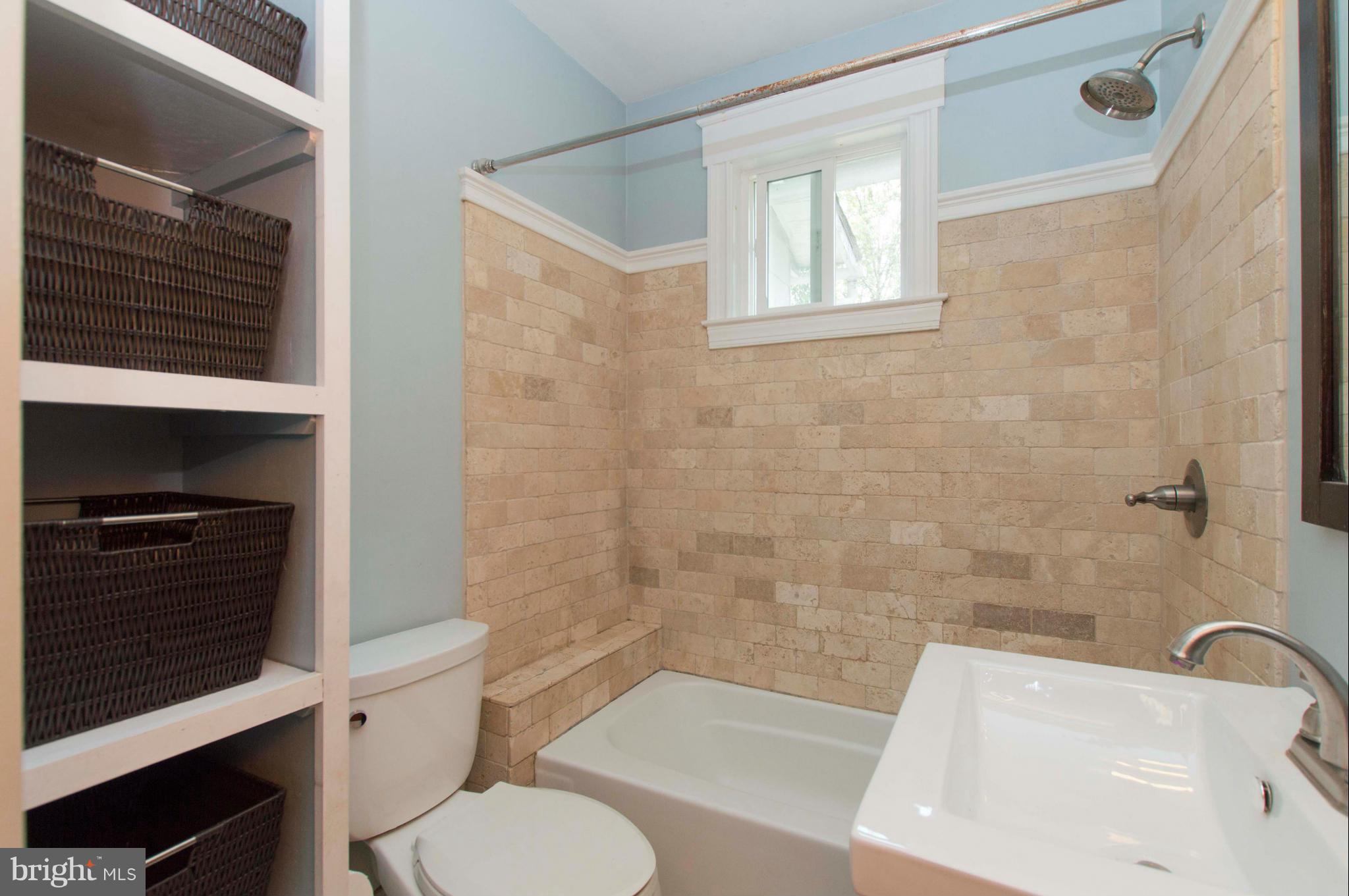 1007 Overbrook Road Baltimore, MD 21239 - Photo 19 of 30 a bathroom with a sink a toilet and shower
