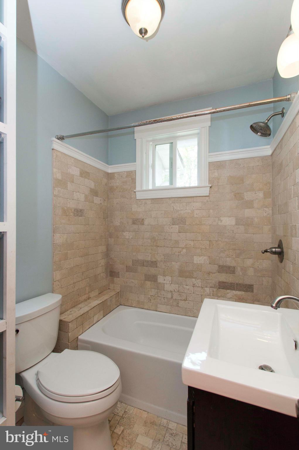 1007 Overbrook Road Baltimore, MD 21239 - Photo 21 of 30 a bathroom with a sink a toilet and bathtub