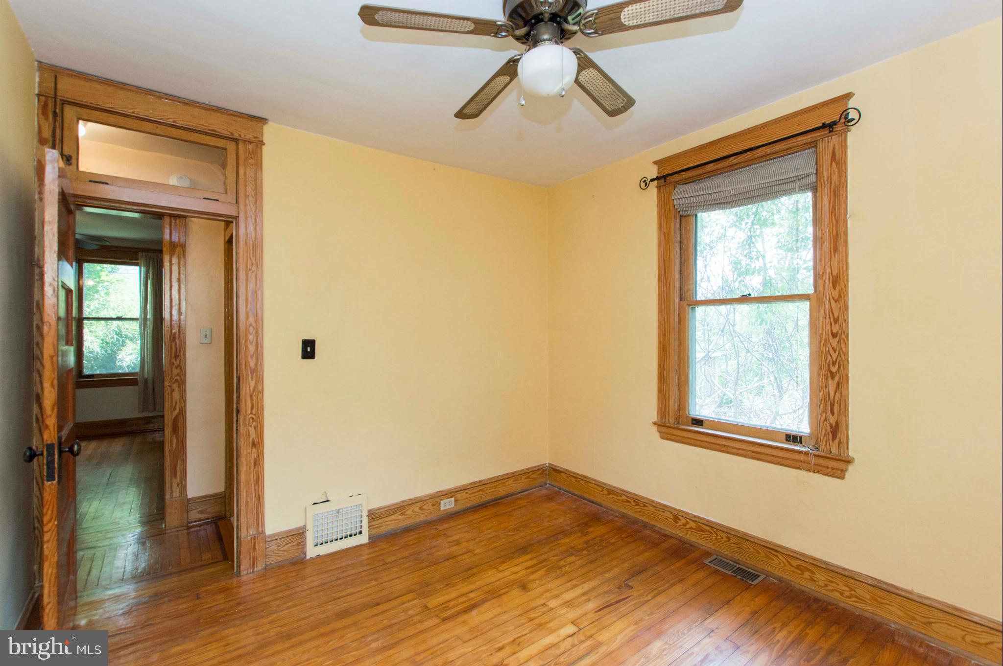 1007 Overbrook Road Baltimore, MD 21239 - Photo 23 of 30 a view of empty room with wooden floor and fan