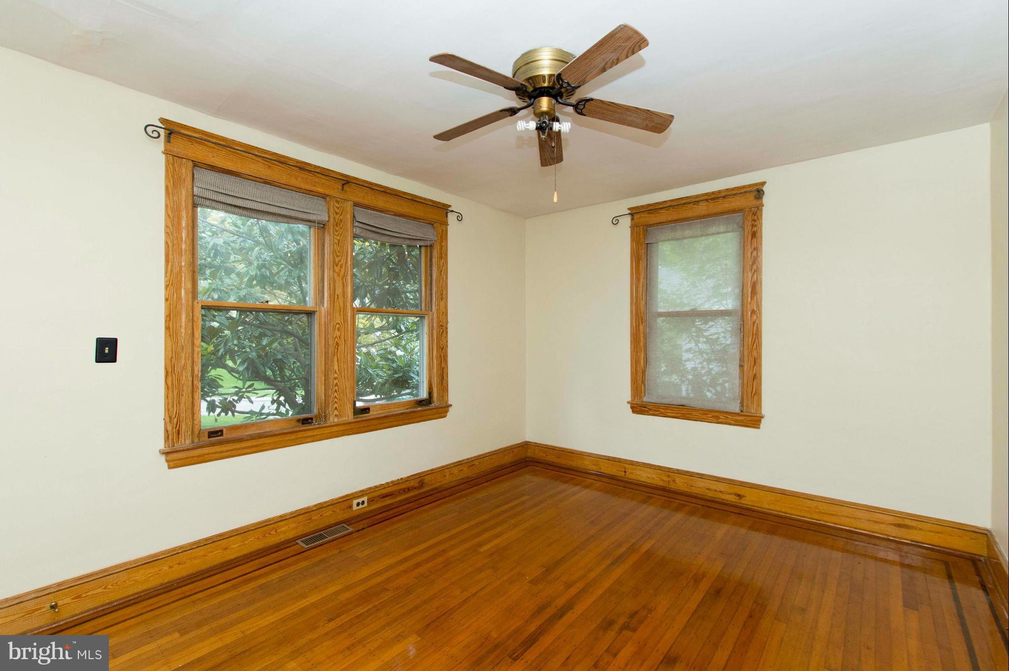 1007 Overbrook Road Baltimore, MD 21239 - Photo 8 of 30 a view of an empty room with a window and wooden floor