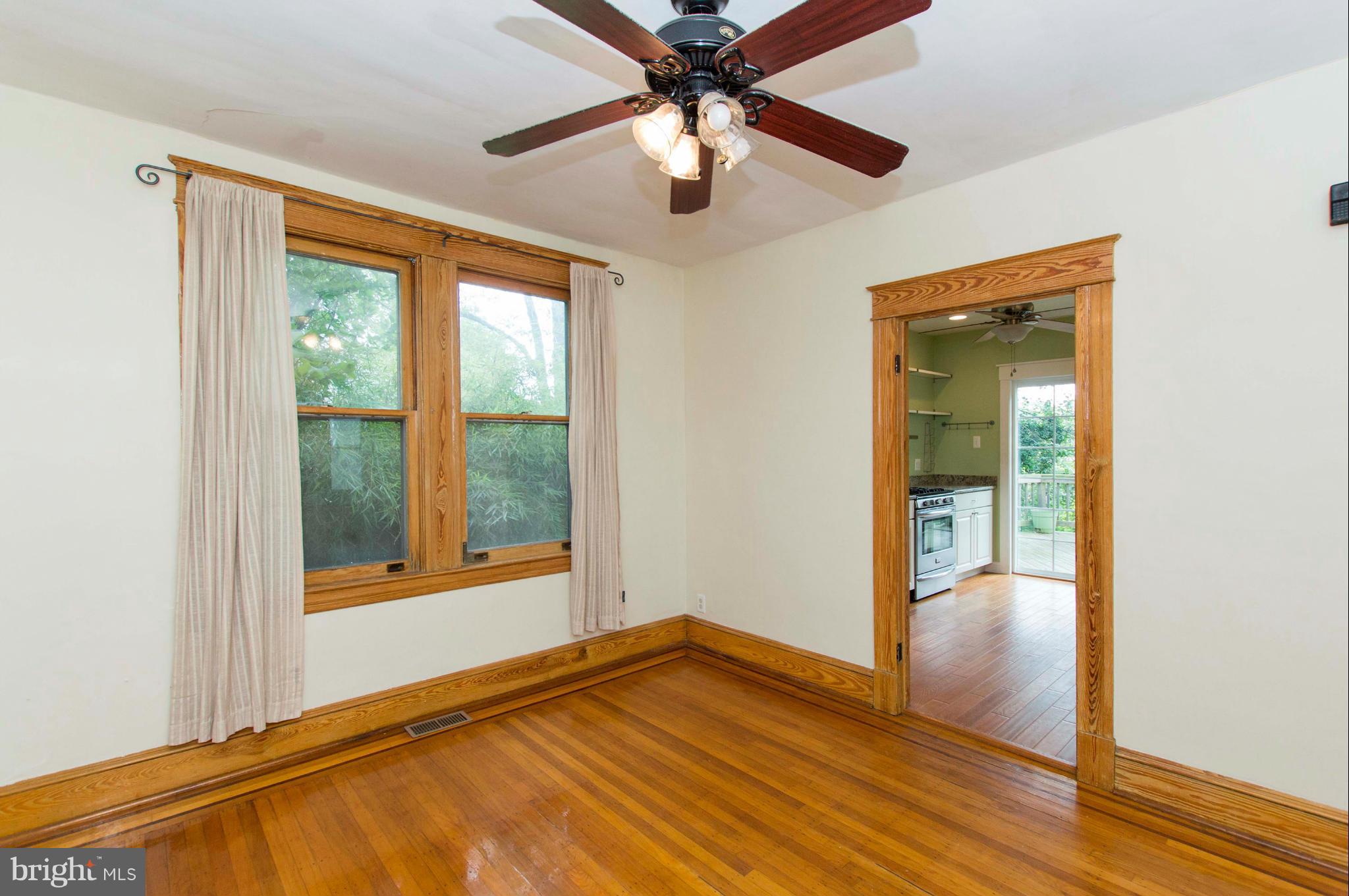 1007 Overbrook Road Baltimore, MD 21239 - Photo 9 of 30 a view of an empty room with window and wooden floor