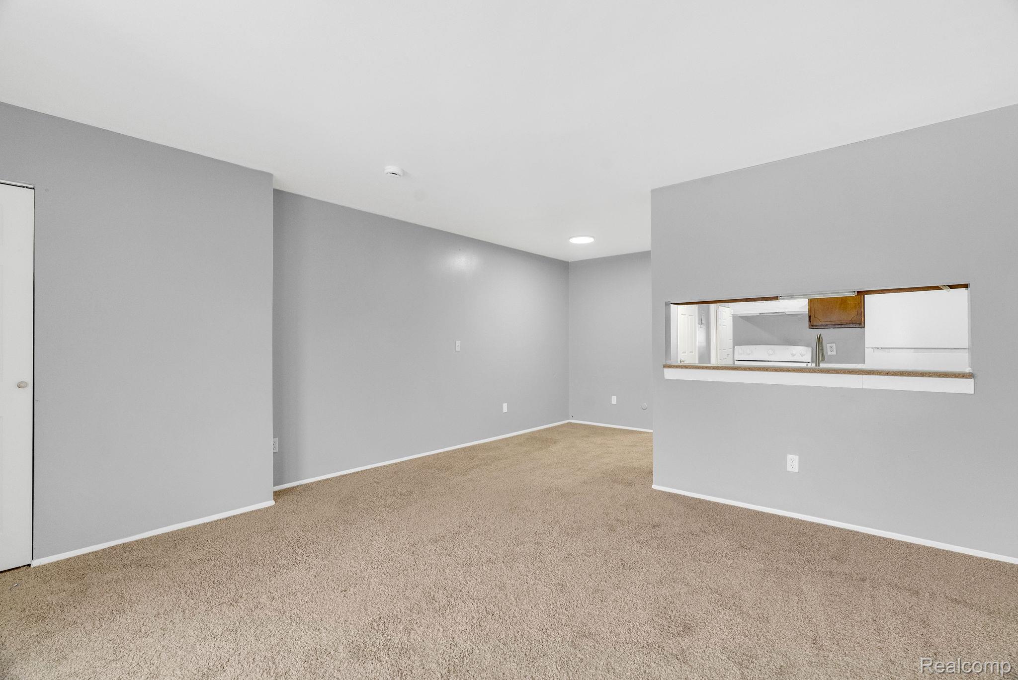 4535 Cadieux Road, Unit 42 / 210 Detroit, MI 48224 - Photo 5 of 16 Unfurnished room featuring light colored carpet and recessed lighting