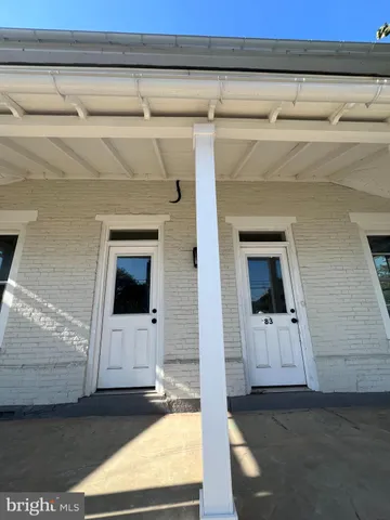 a view of a livingroom with an empty space and a fireplace