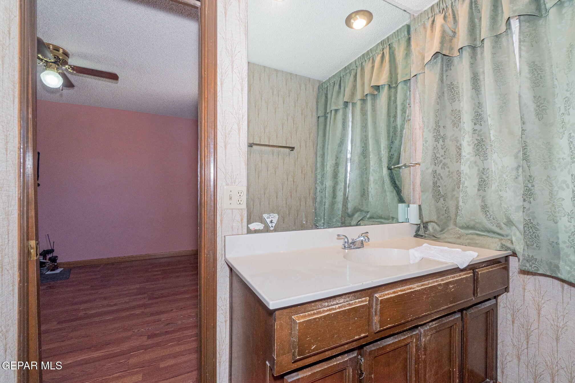 4643 R L Shoemaker Drive El Paso, TX 79924 - Photo 15 of 24 a bathroom with a sink and a mirror