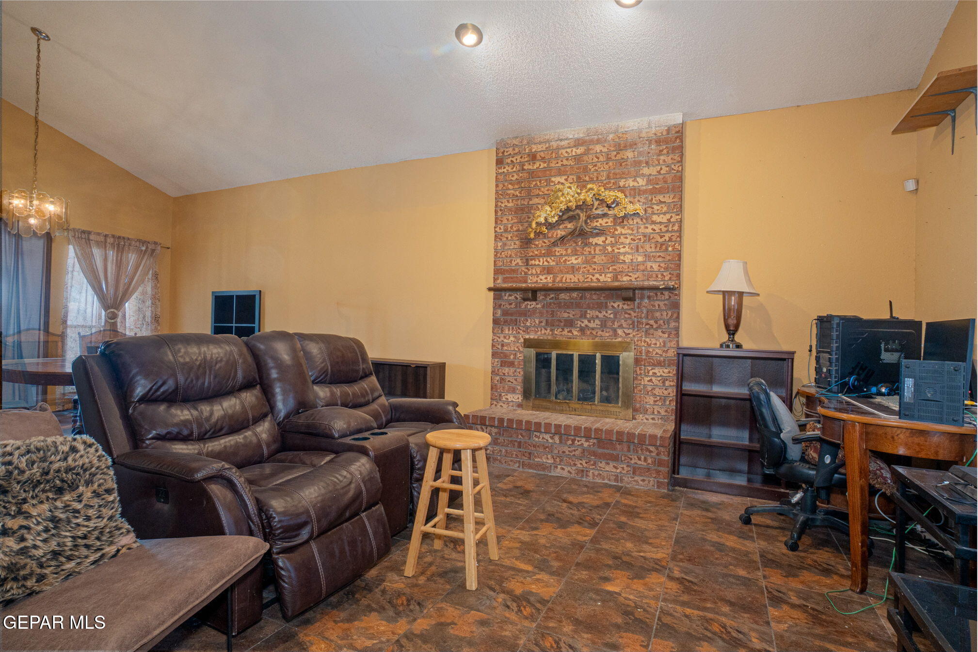 4643 R L Shoemaker Drive El Paso, TX 79924 - Photo 4 of 24 a living room with furniture a fireplace and a flat screen tv