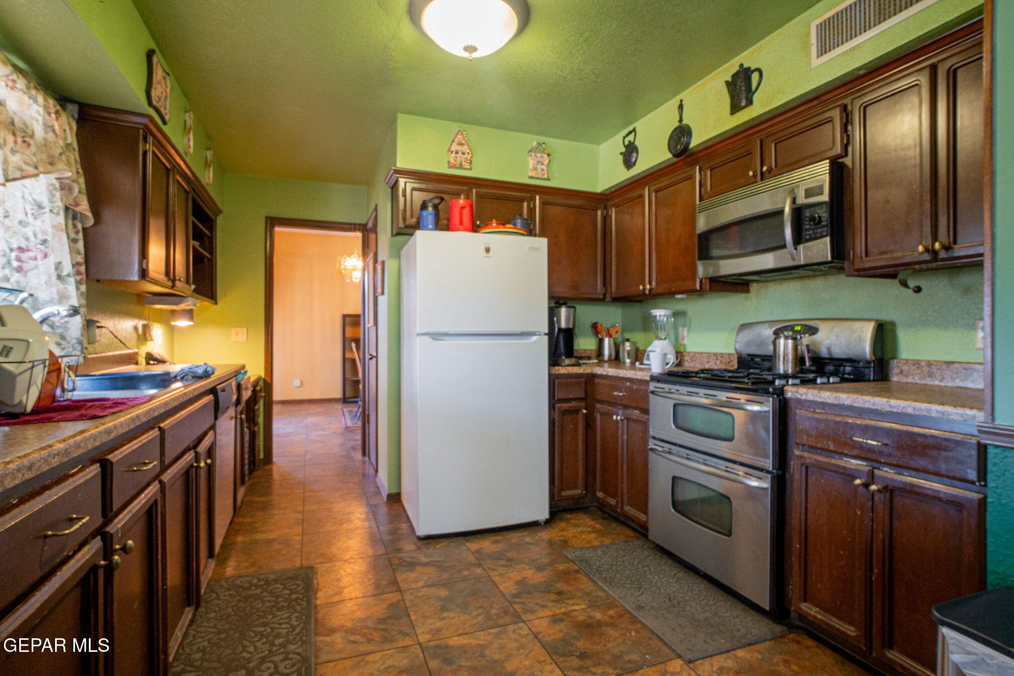 4643 R L Shoemaker Drive El Paso, TX 79924 - Photo 6 of 24 a kitchen with stainless steel appliances granite countertop a refrigerator a stove top oven a sink and dishwasher