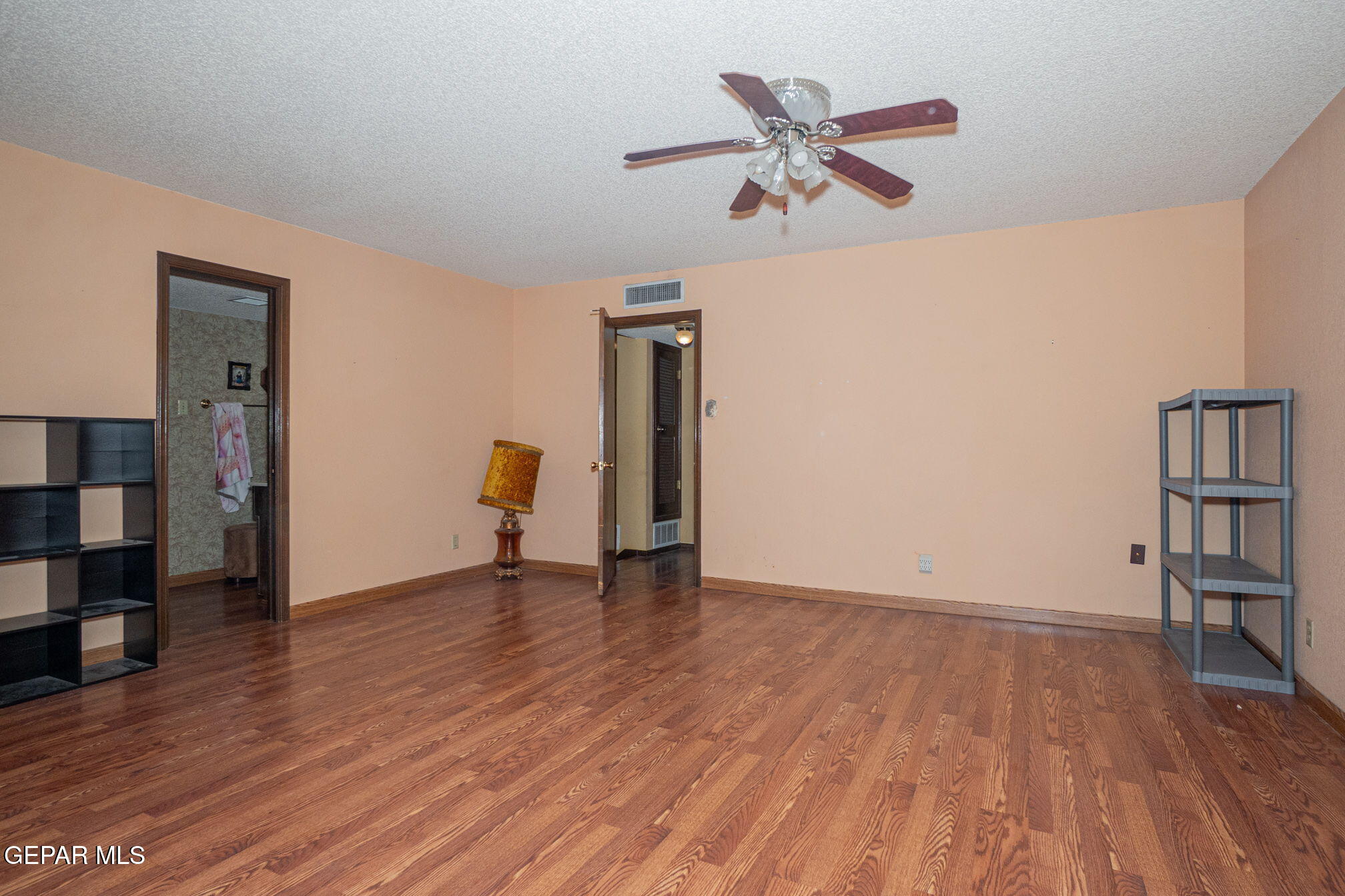 4643 R L Shoemaker Drive El Paso, TX 79924 - Photo 10 of 24 a view of room with hardwood floor and a ceiling fan