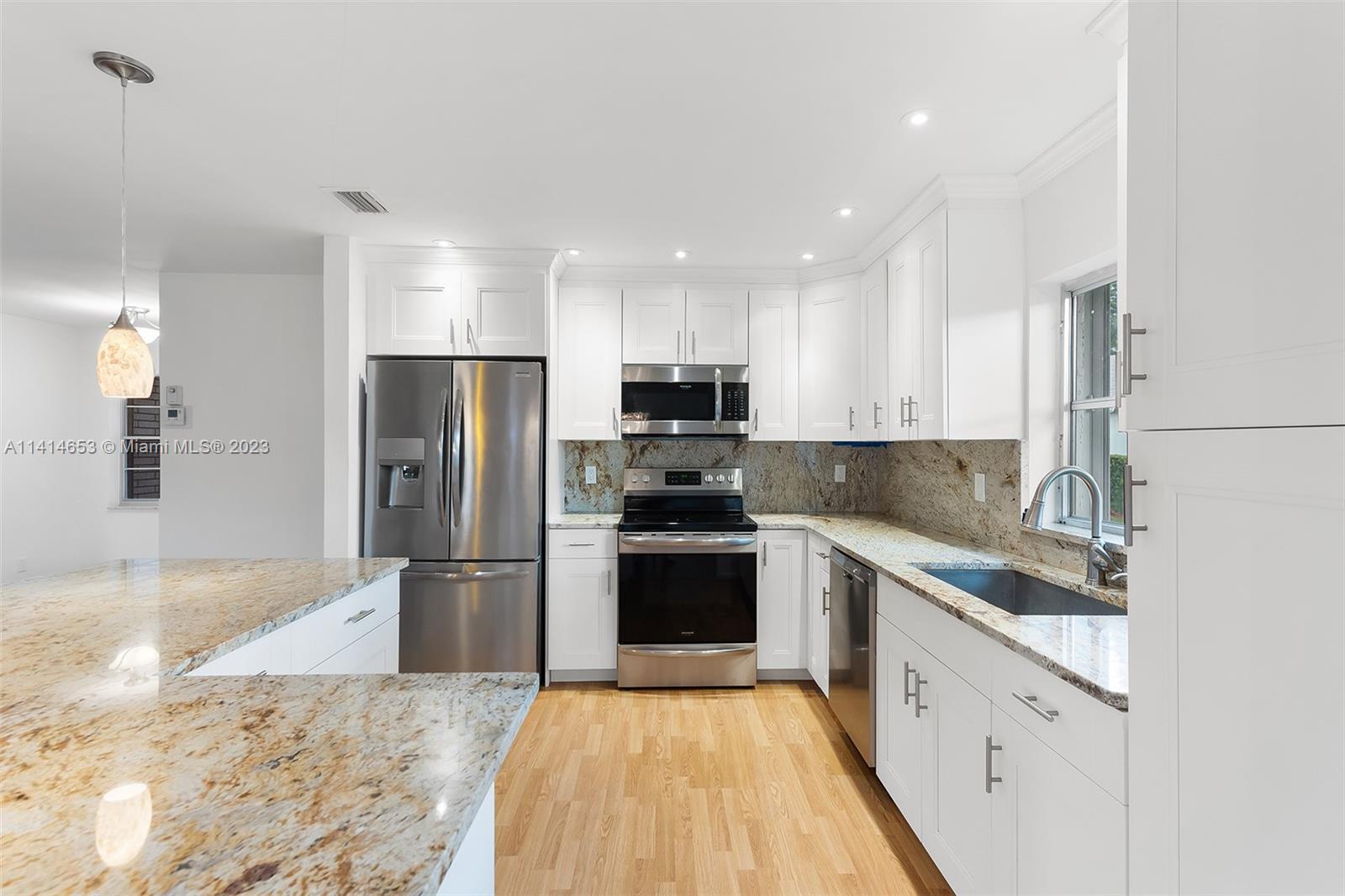 6240 Dusenburg Road Delray Beach, FL 33484 - Photo 12 of 25 a large kitchen with cabinets stainless steel appliances and a counter space