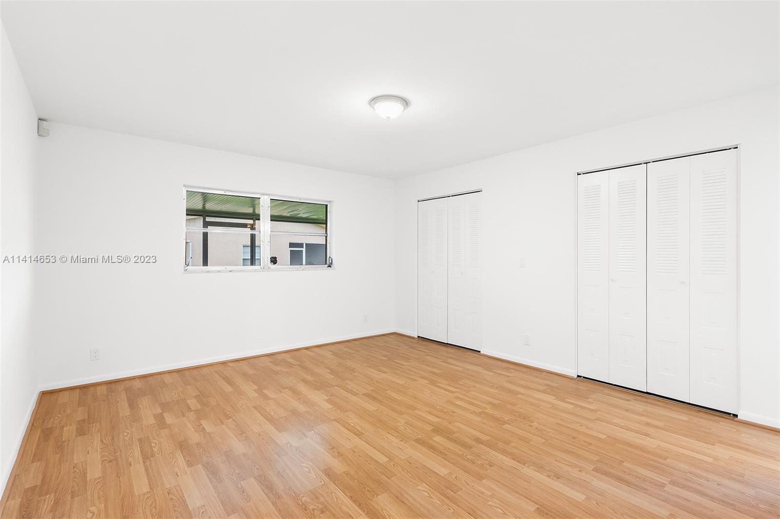 6240 Dusenburg Road Delray Beach, FL 33484 - Photo 14 of 25 a view of empty room with wooden floor and fan