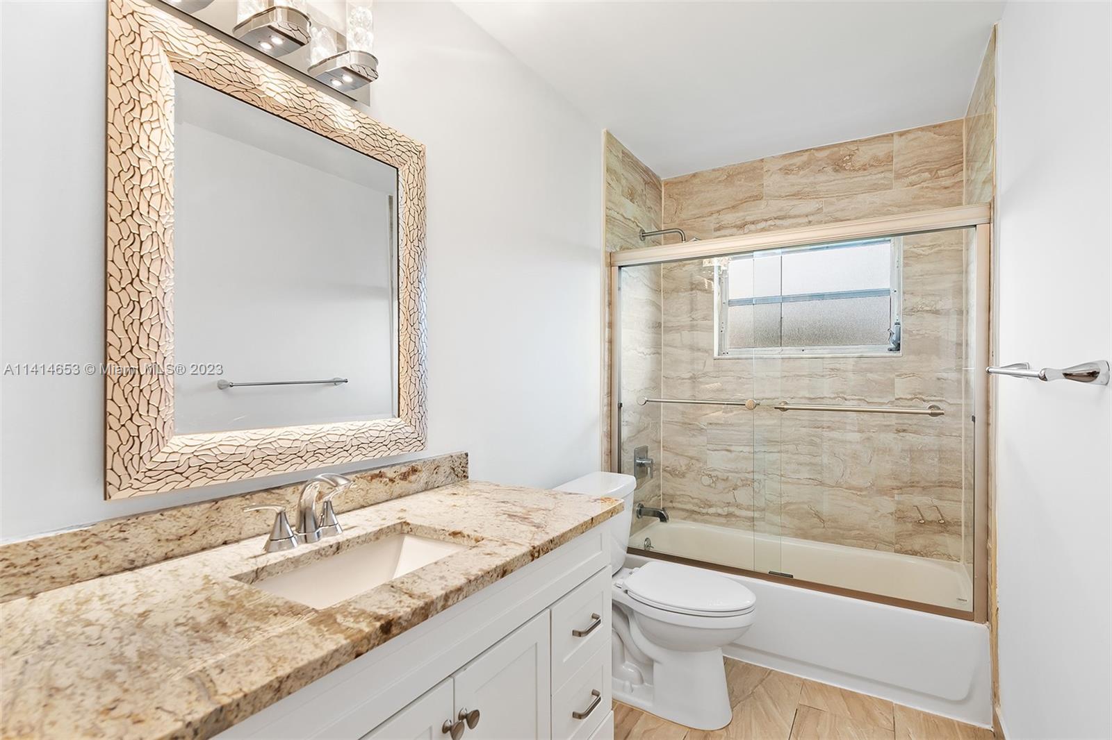6240 Dusenburg Road Delray Beach, FL 33484 - Photo 19 of 25 a bathroom with a granite countertop sink toilet and shower