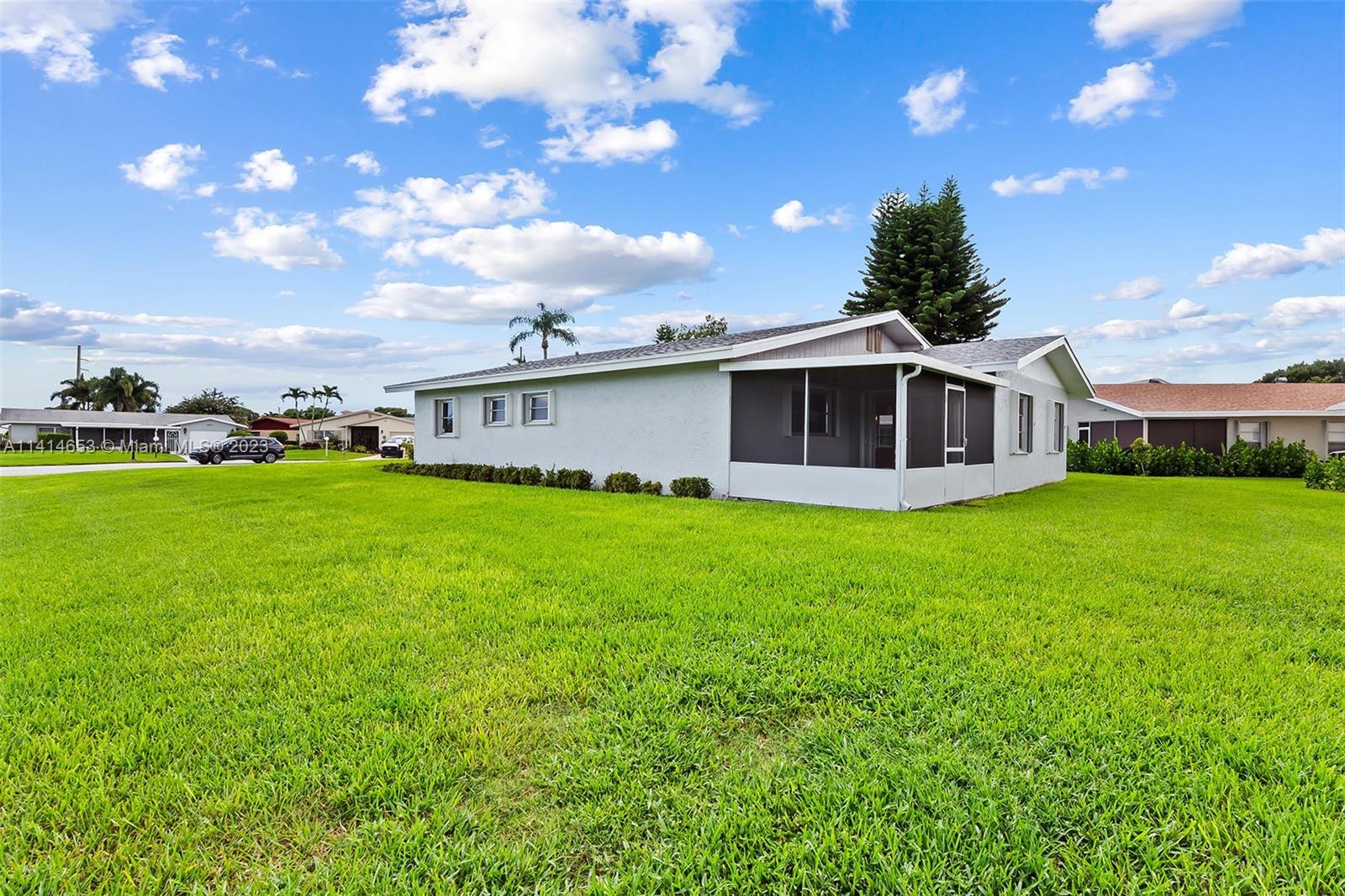6240 Dusenburg Road Delray Beach, FL 33484 - Photo 24 of 25 a view of a house with a backyard porch and sitting area