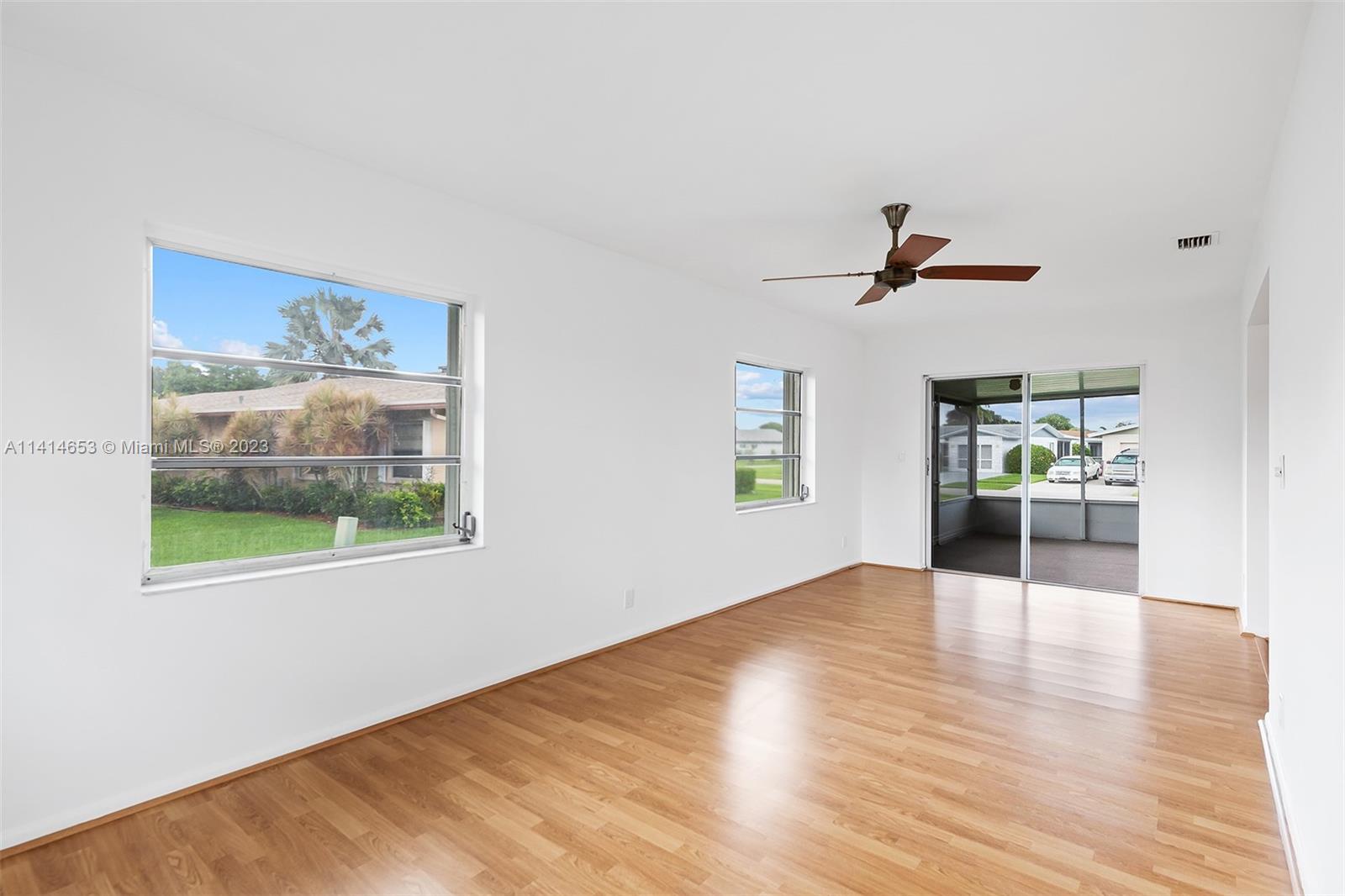 6240 Dusenburg Road Delray Beach, FL 33484 - Photo 5 of 25 a view of a livingroom with a window and wooden floor
