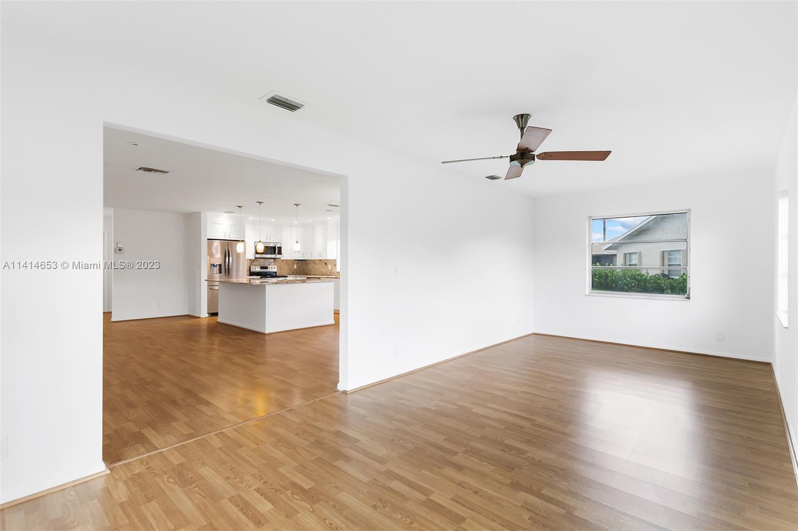 6240 Dusenburg Road Delray Beach, FL 33484 - Photo 6 of 25 a view of a kitchen with wooden floor and a ceiling fan
