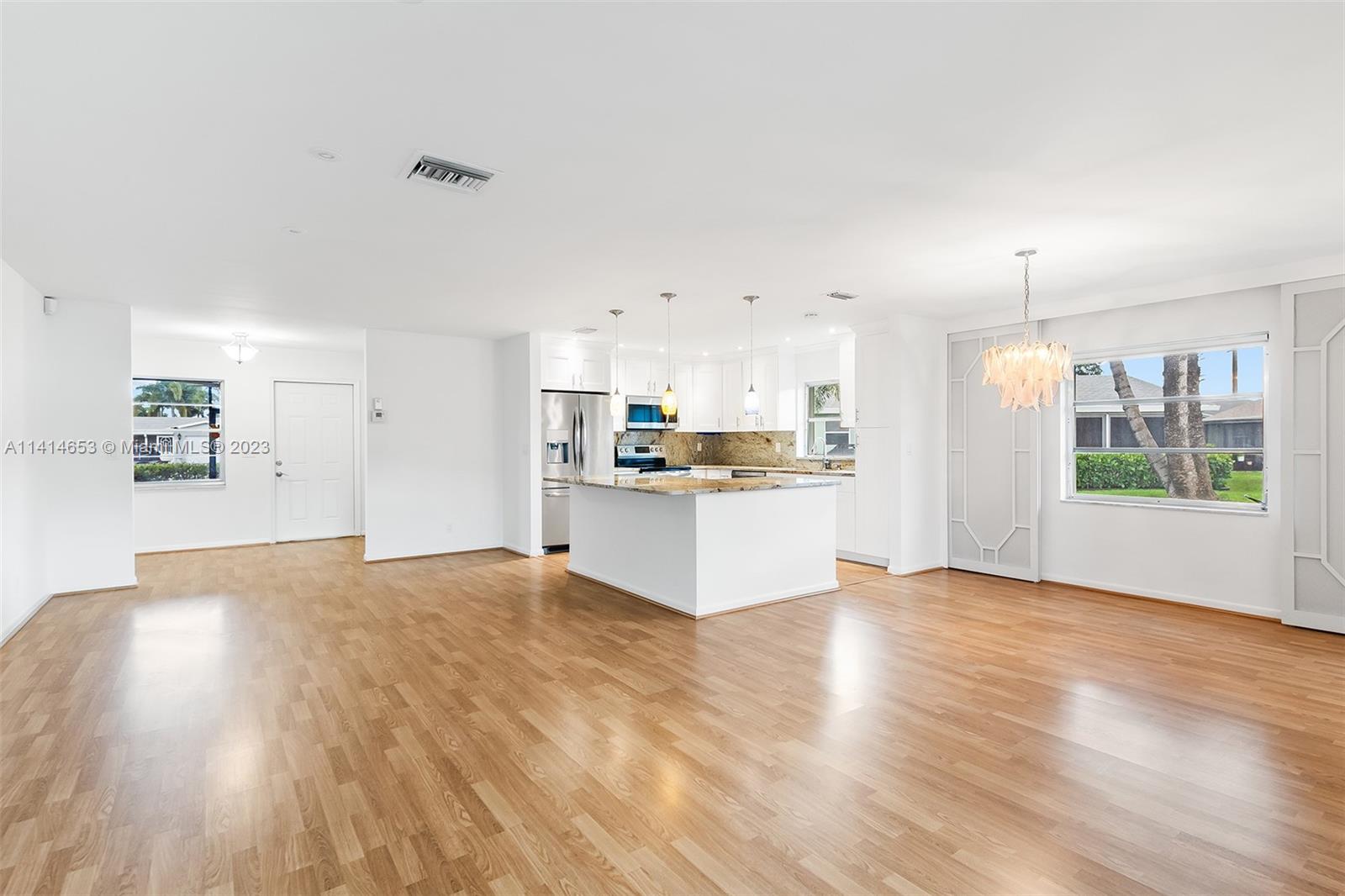 6240 Dusenburg Road Delray Beach, FL 33484 - Photo 8 of 25 a view of kitchen with wooden floor and window