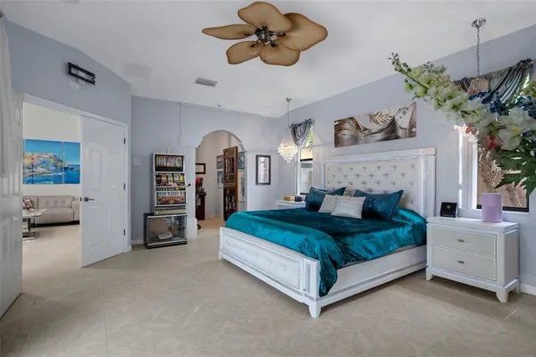 a view of a livingroom with wooden floor and a ceiling fan