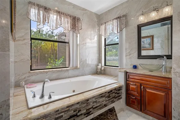 a bathroom with double vanity sinks and a mirror