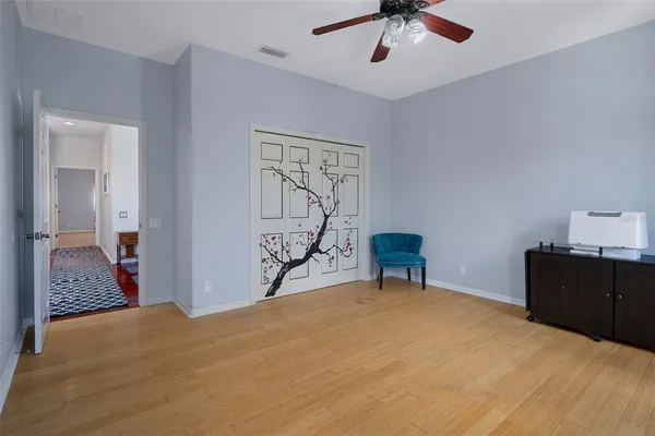a bedroom with a bed and a painting on the wall