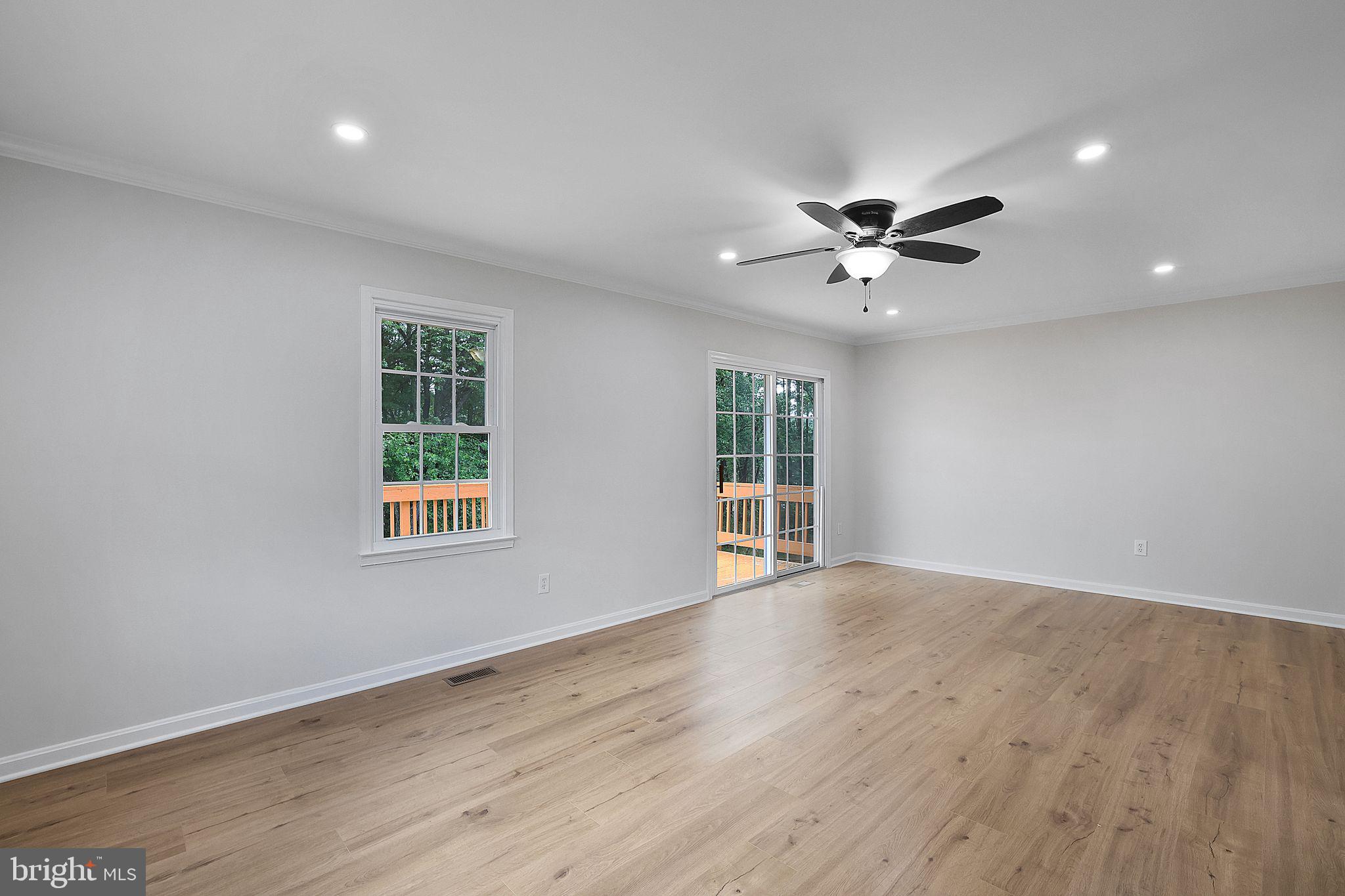 7760 Euclid Way Springfield, VA 22153 - Photo 11 of 50 an empty room with wooden floor and windows