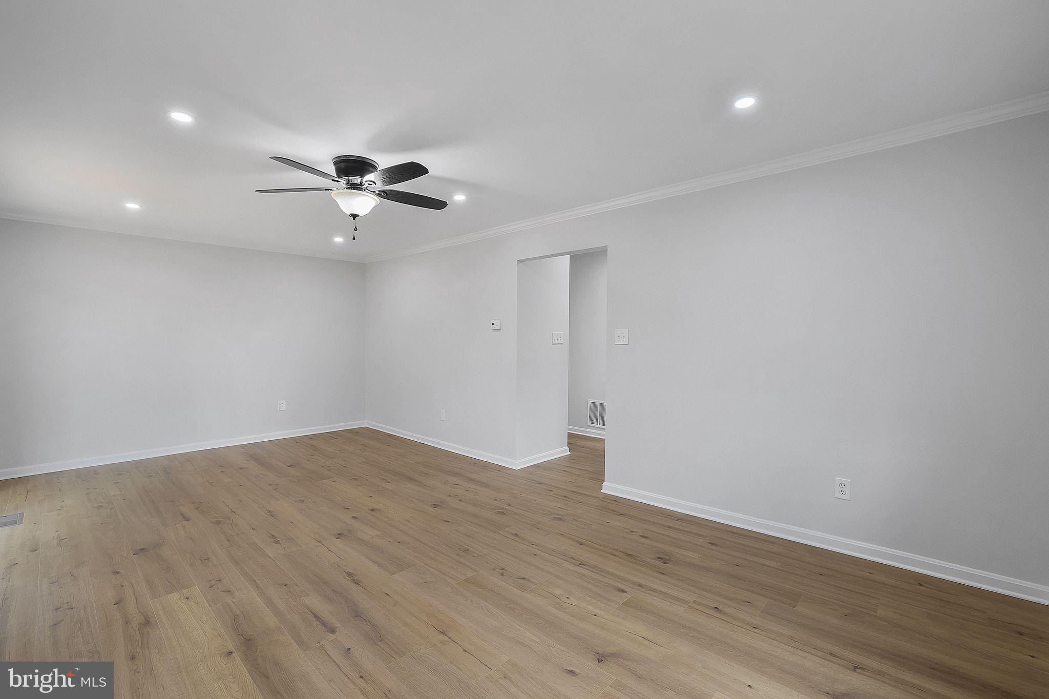 7760 Euclid Way Springfield, VA 22153 - Photo 13 of 50 a view of a big room with wooden floor and a ceiling fan