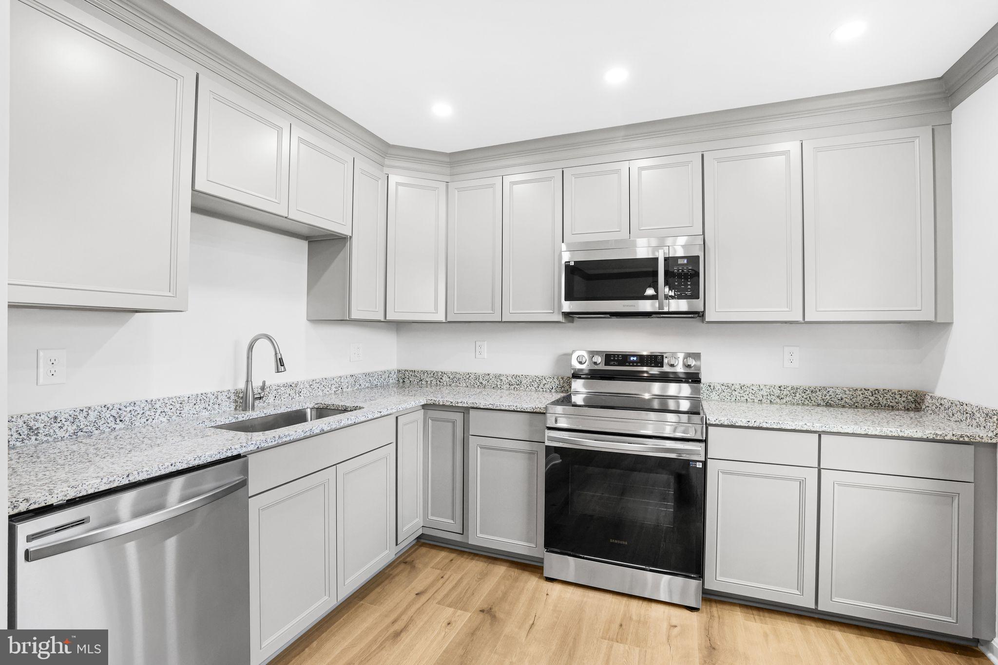 7760 Euclid Way Springfield, VA 22153 - Photo 3 of 50 a kitchen with granite countertop white cabinets sink and stainless steel appliances