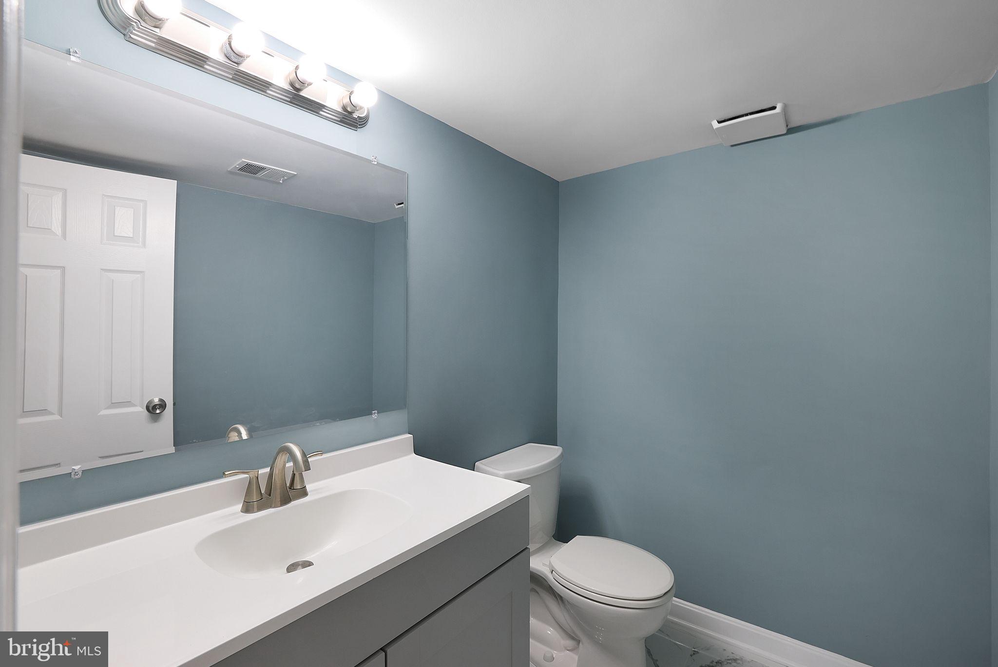 7760 Euclid Way Springfield, VA 22153 - Photo 39 of 50 a bathroom with a sink a toilet and a mirror