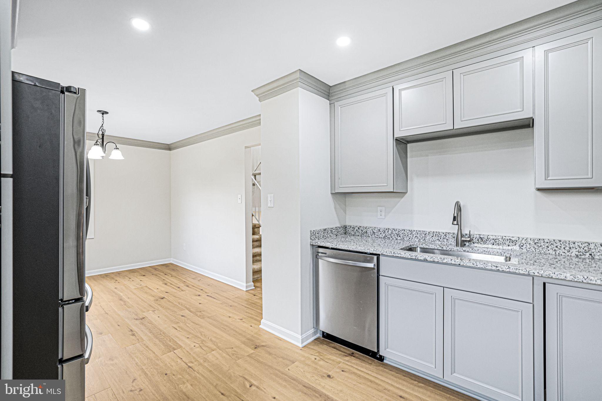 7760 Euclid Way Springfield, VA 22153 - Photo 5 of 50 a kitchen with a sink a refrigerator and cabinets