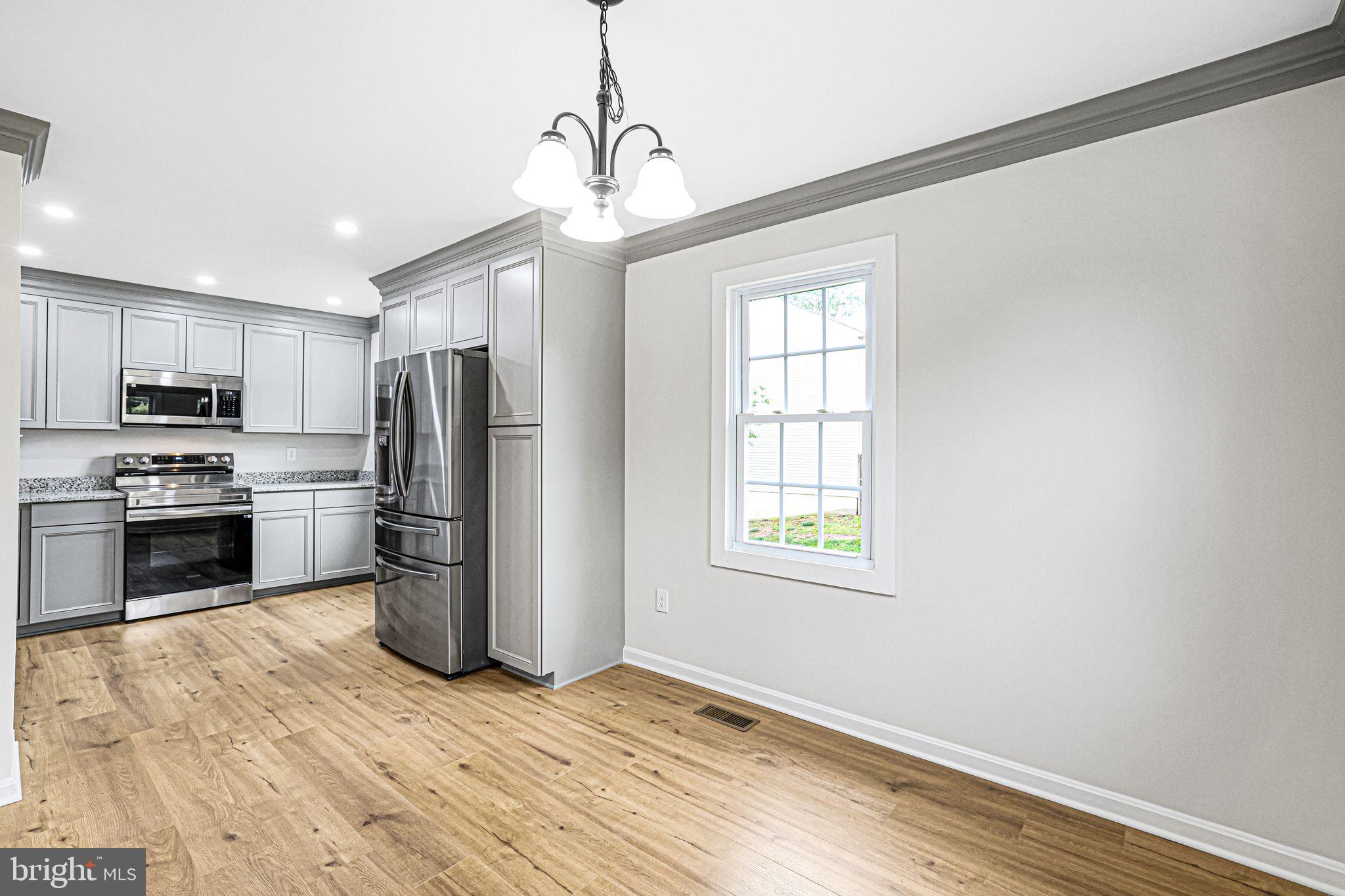 7760 Euclid Way Springfield, VA 22153 - Photo 6 of 50 a kitchen with a refrigerator and a stove top oven
