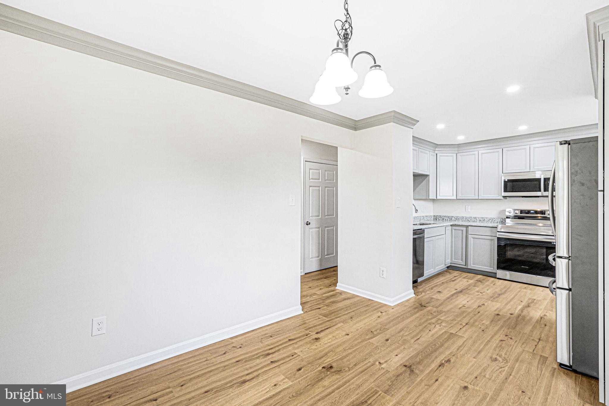 7760 Euclid Way Springfield, VA 22153 - Photo 7 of 50 a view of a kitchen with a sink and dishwasher a refrigerator with wooden floor