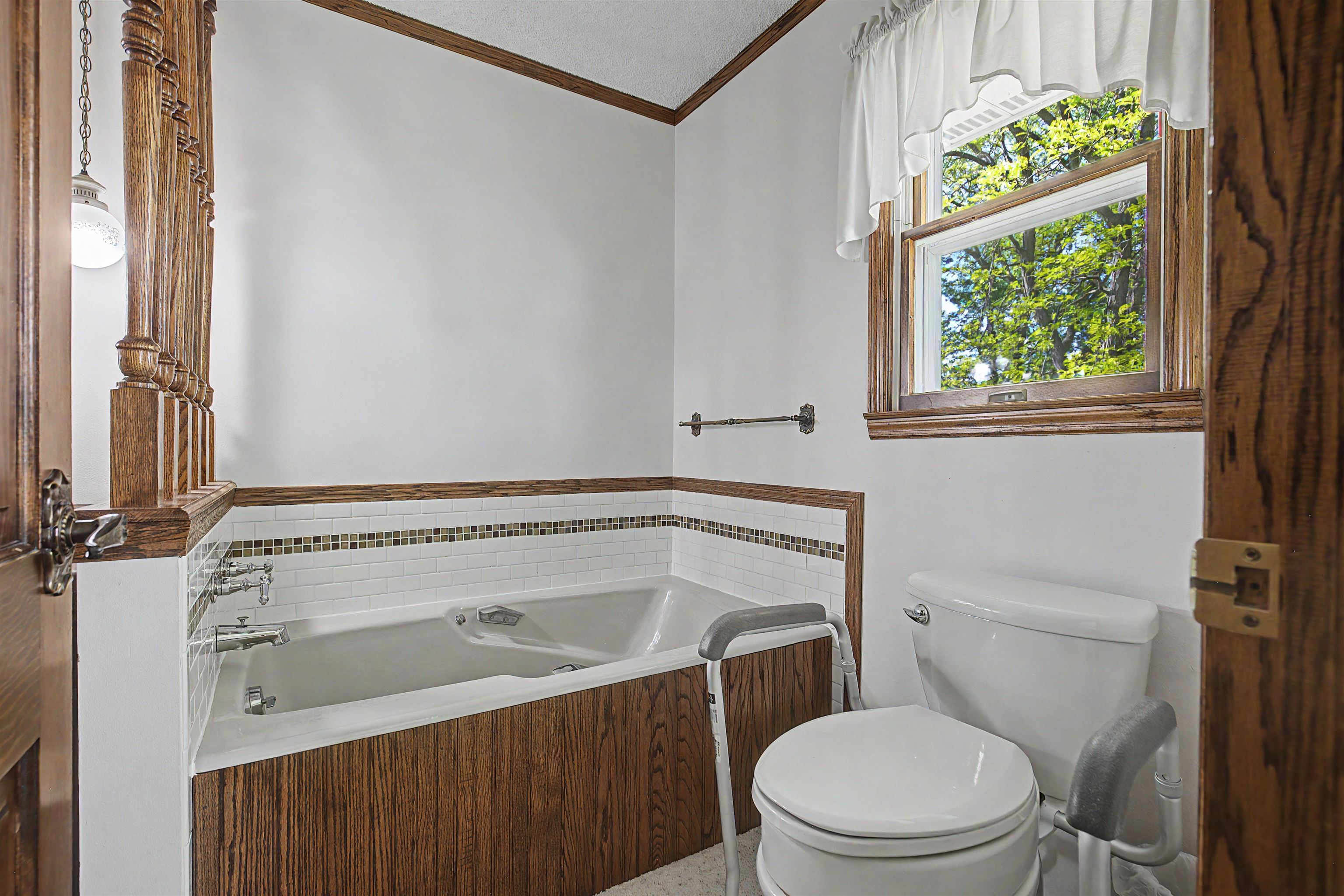 17380 Corbett Road Mount Carroll, IL 61053 - Photo 39 of 65 a bathroom with a sink a toilet and a window