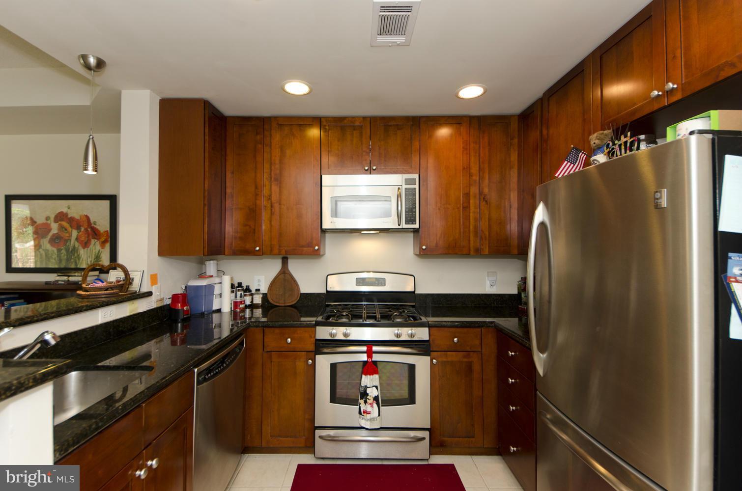 3600 South Glebe Road, Unit 235W Arlington, VA 22202 - Photo 3 of 30 a kitchen with granite countertop a refrigerator stove and sink