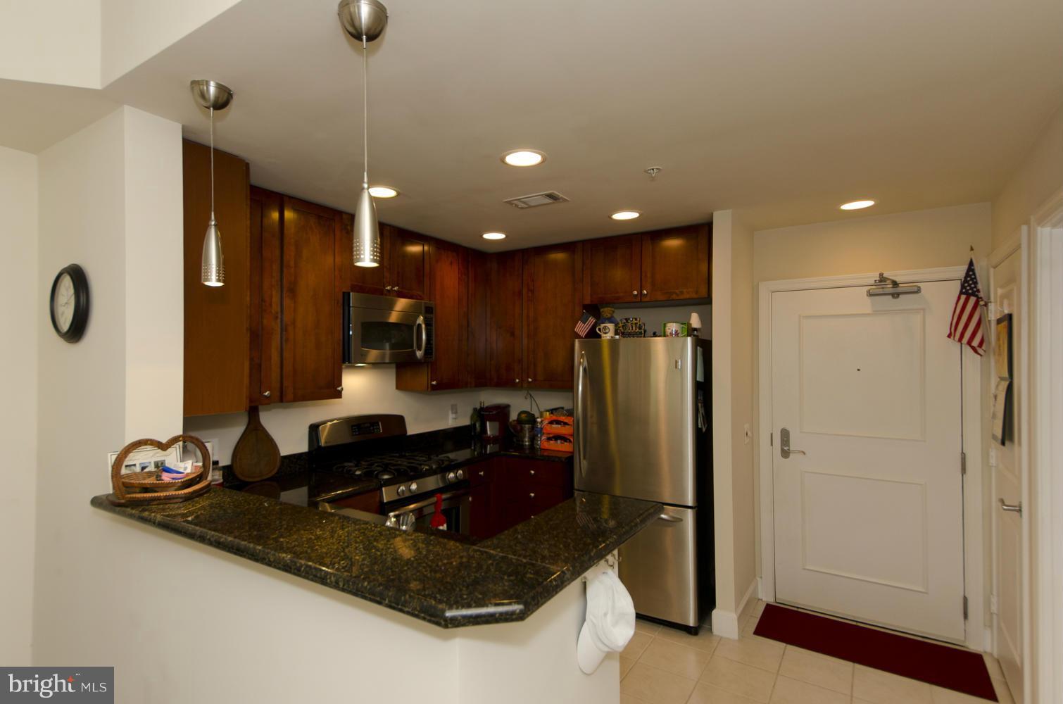 3600 South Glebe Road, Unit 235W Arlington, VA 22202 - Photo 4 of 30 a kitchen with stainless steel appliances granite countertop a refrigerator and a stove
