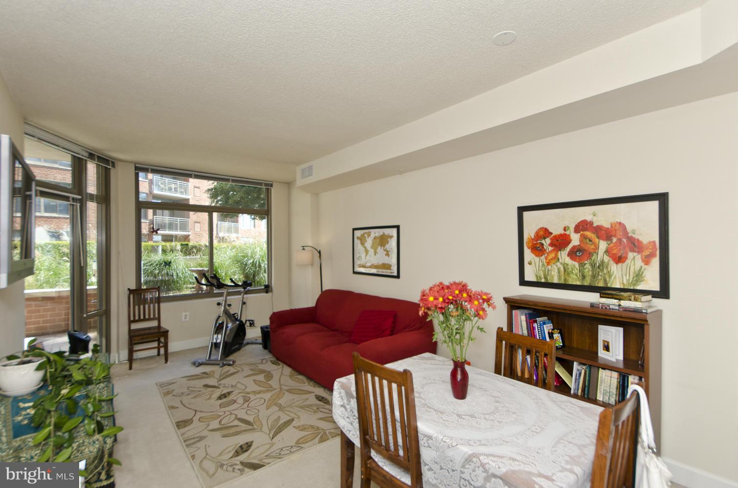 3600 South Glebe Road, Unit 235W Arlington, VA 22202 - Photo 5 of 30 a living room with furniture a flat screen tv and a large window
