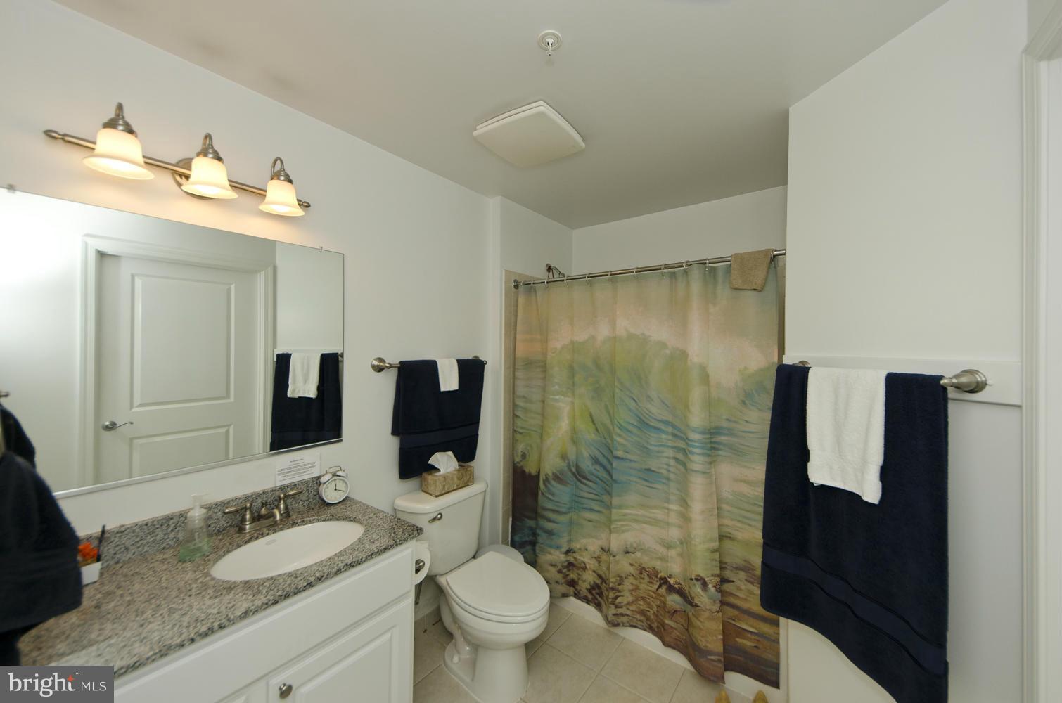 3600 South Glebe Road, Unit 235W Arlington, VA 22202 - Photo 10 of 30 a bathroom with a granite countertop sink mirror and toilet