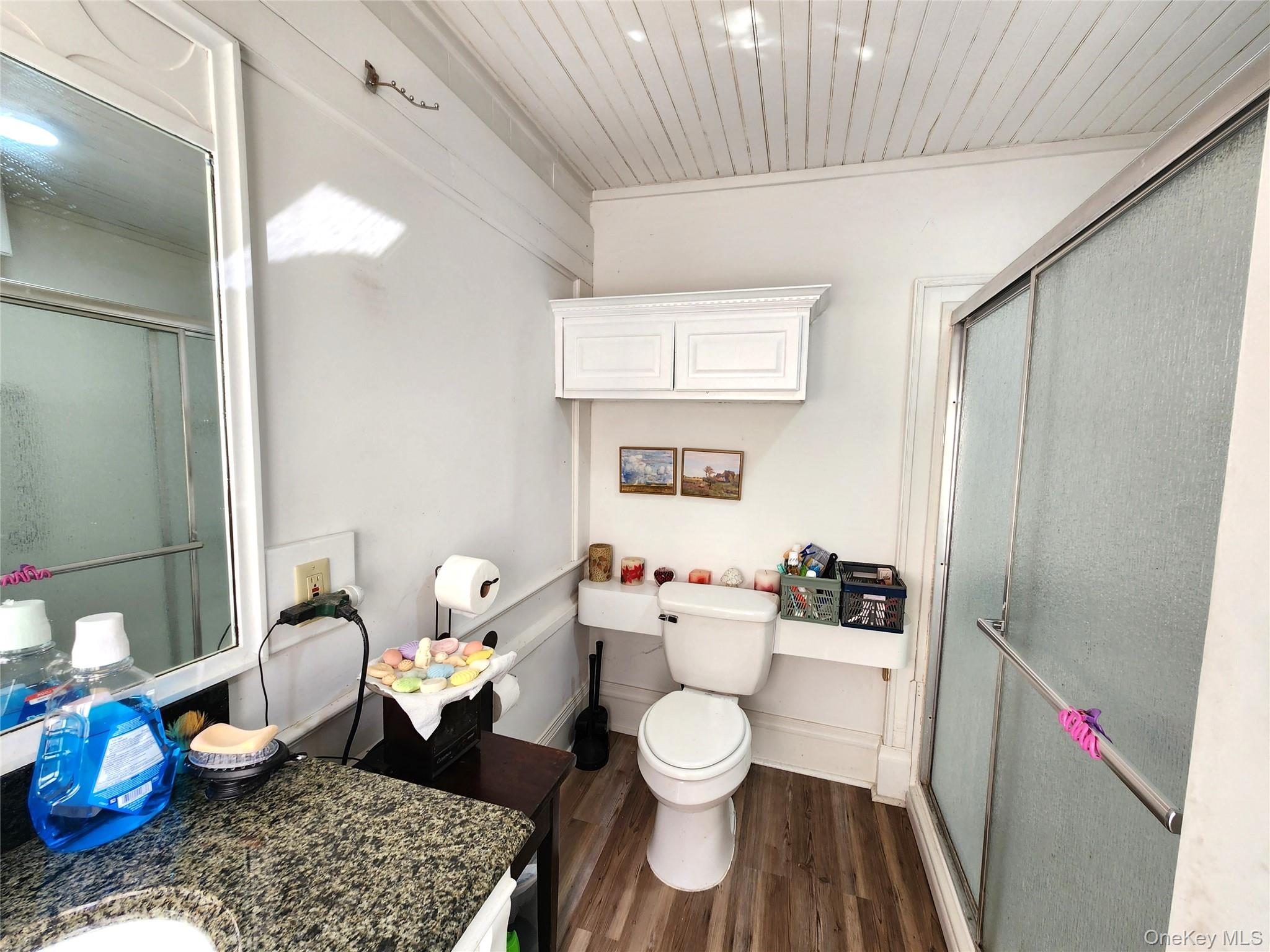 35 Youngs Hill Road Liberty, NY 12754 - Photo 23 of 32 a white toilet sitting next to a bathroom sink and vanity