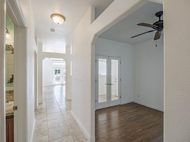 a bathroom with a granite countertop sink a toilet and a mirror