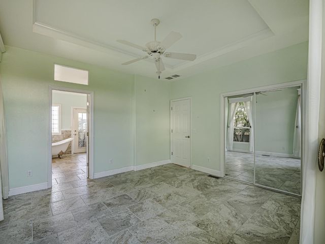 a spacious bathroom with a granite countertop sink and a bathtub