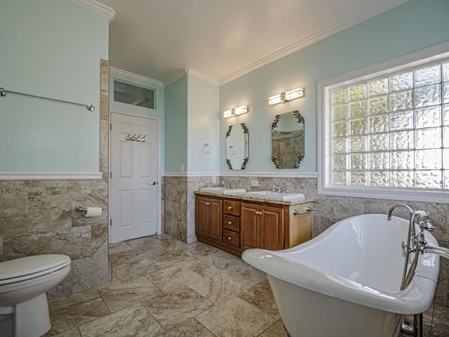 a view of staircase with railing and white walls