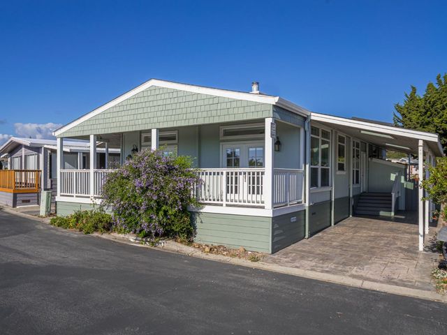 a view of a balcony with wooden floor and fence