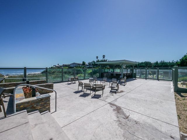 a view of a garden with a building in the background